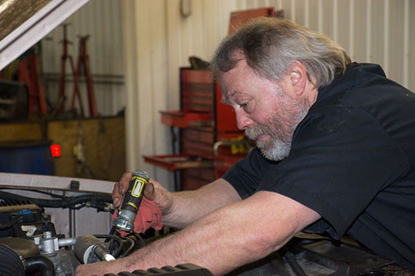 Technician diagnosing an engine